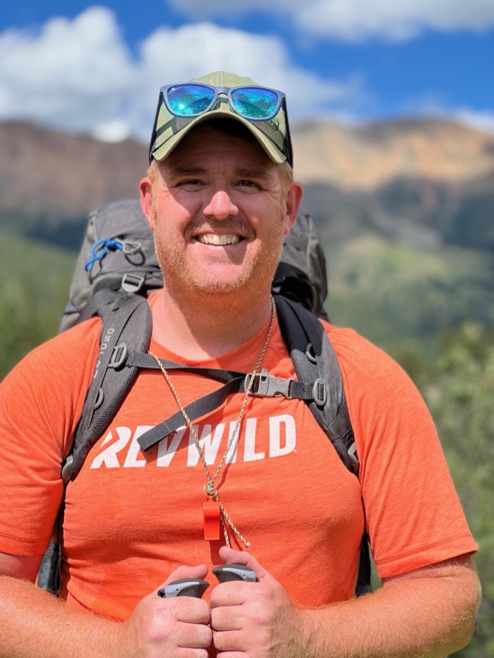 Nick Johnson, founder of Relentless Pursuit, smiling on a mountain hike